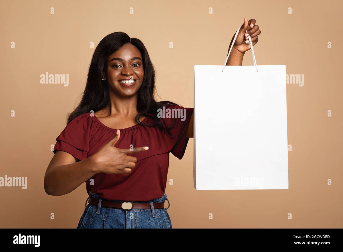 Happy black lady holding white paper bag, mockup Stock Photo Alamy