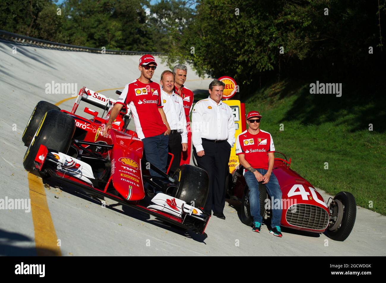 The Ferrari SF15-T and Ferrari 166 F2 cars on the Monza banking at a Shell photoshoot (L to R): Sebastian Vettel (GER) Ferrari; John Abbott, Shell Downstream Director; Maurizio Arrivabene (ITA) Ferrari Team Principal; Istvan Kapitany, Shell Executive Vice President, Retail; and Kimi Raikkonen (FIN) Ferrari. Italian Grand Prix, Saturday 5th September 2015. Monza Italy. Stock Photo