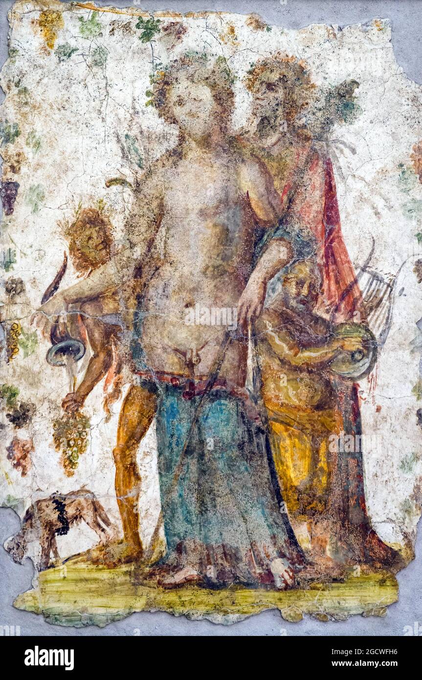 Dionysus and a Maenad  the god assisted by a Maenad, a young Satyr and a Silenus with zither, from a rython pours the wine that is licked by the panther fresco Pompeii 62-79 AD Stock Photo