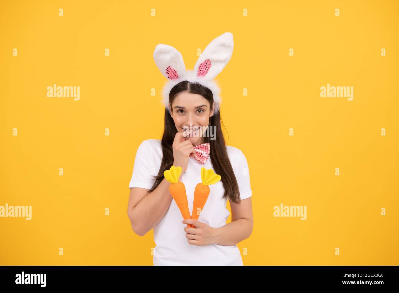 happy bunny woman in rabbit ears with carrot, easter Stock Photo