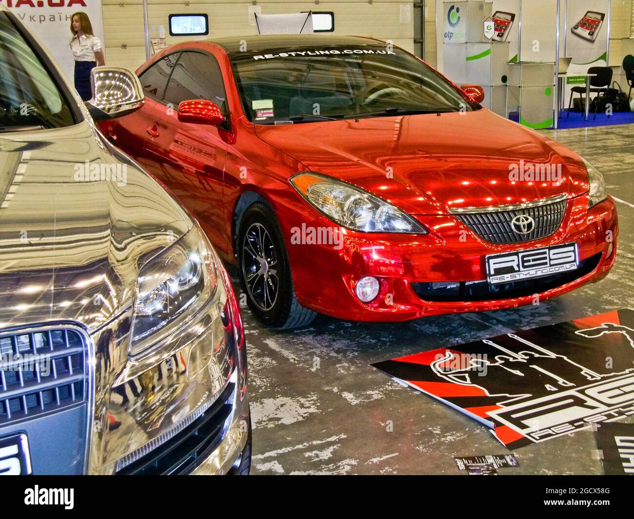 Kiev, Ukraine; April 10, 2014. Red Magnetic chrome Audi Q7 and Toyota Solara Stock Photo