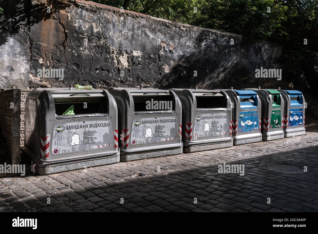 Separate trash bins for unsorted waste and recycled types of garbage
