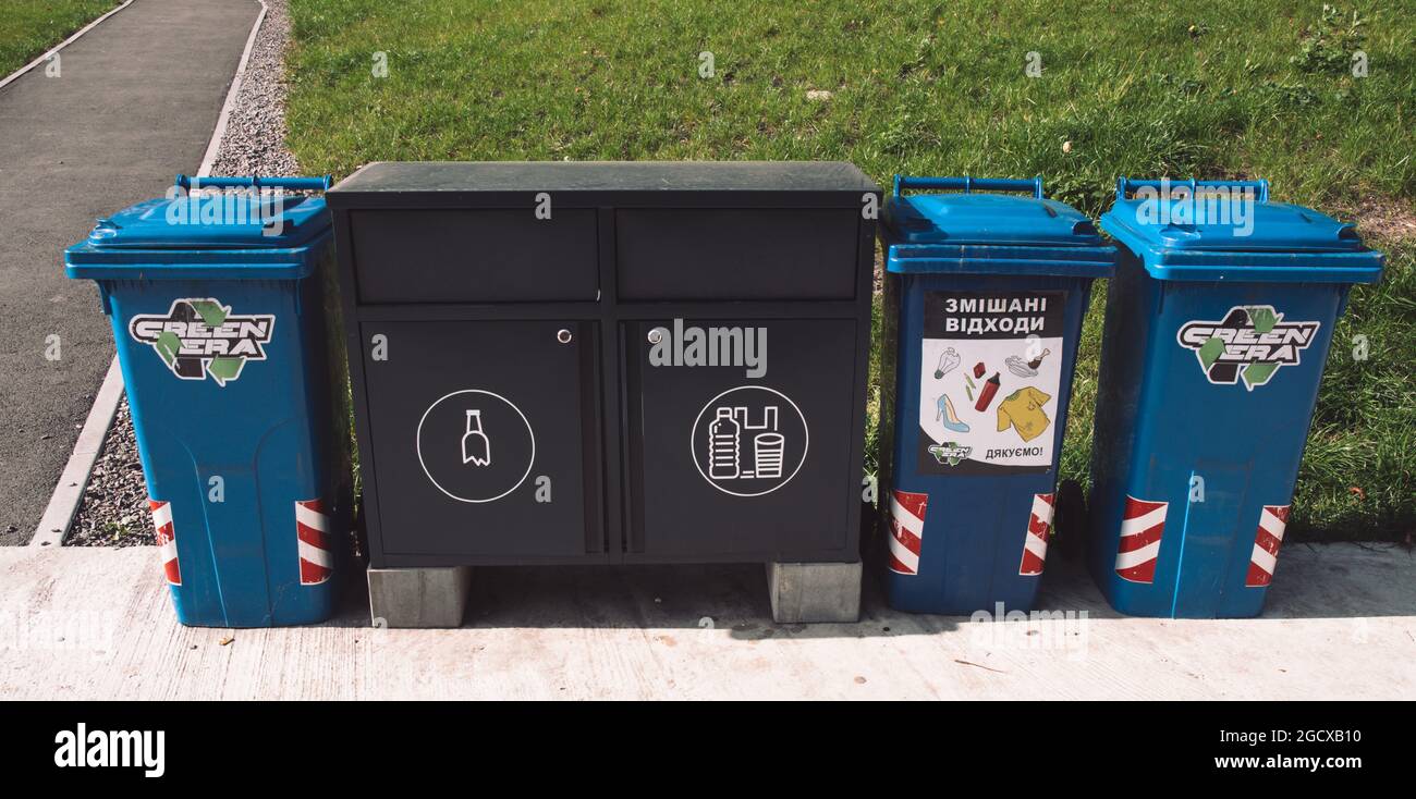 Pavement in park with trash recycling cans and lockers for sorted garbage. Sustainable lifestyle in urban environment. Environmental conservation. Lvi Stock Photo