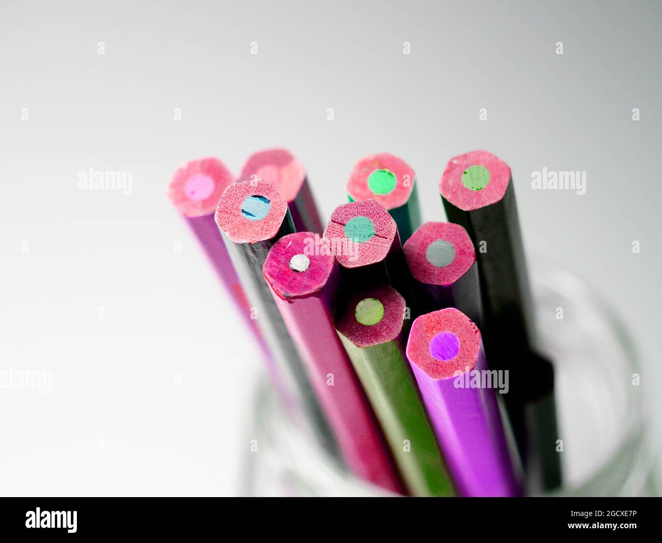 Different colored pencils in a glass Stock Photo