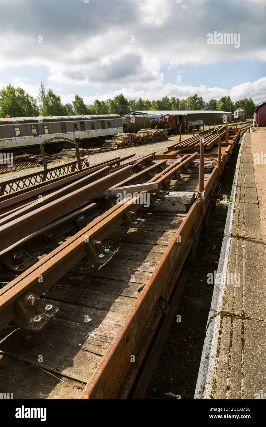 steam railway. Spare  rails stored on old rolling stock. Speyside railways. Boat of Garten Scotland UK Stock Photo
