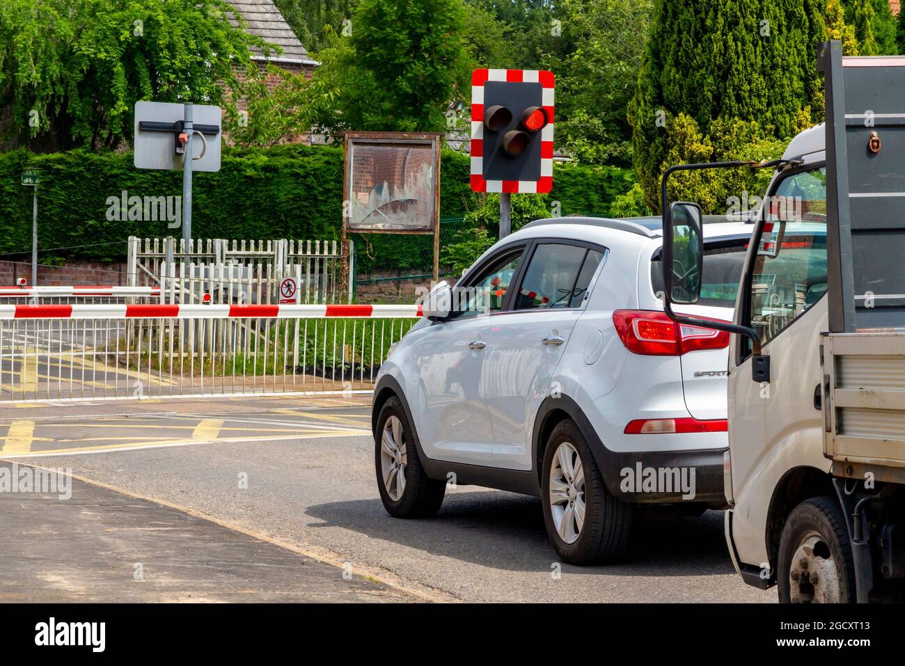 Car and gates at automated level crossing on a railway line at Wainfleet village in Lincolnshire East Midlands England UK Stock Photo