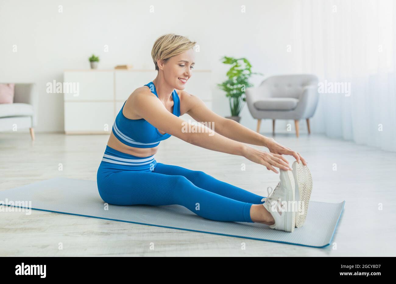 Yoga Indoors: Wide Leg Seated Hamstring Stretch Stock Photo
