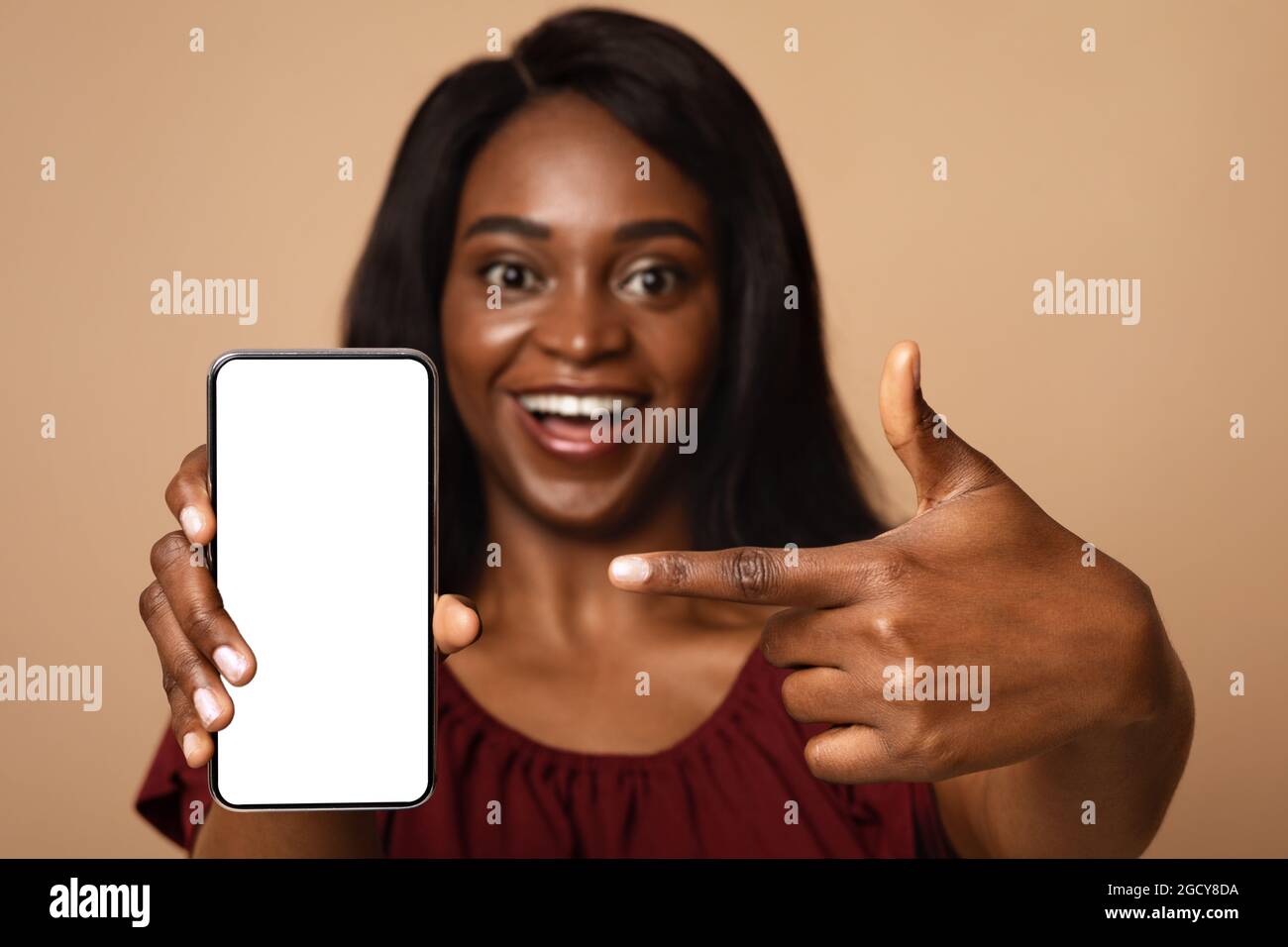 Closeup of black woman pointing at smartphone with empty screen Stock ...