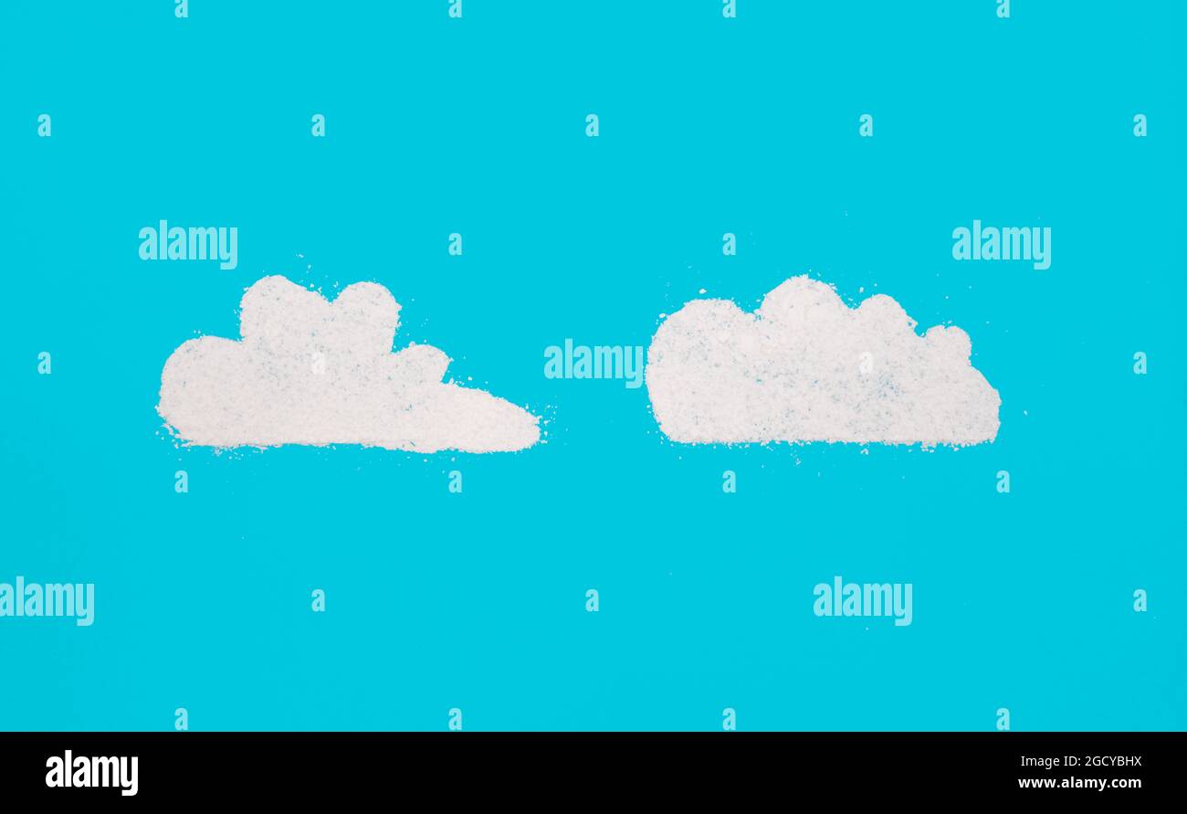 Clouds on light blue background made by powdered suger as abstract concept for food or weather Stock Photo