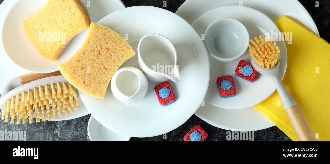Concept of Dishwashing detergent accessories on black smokey table