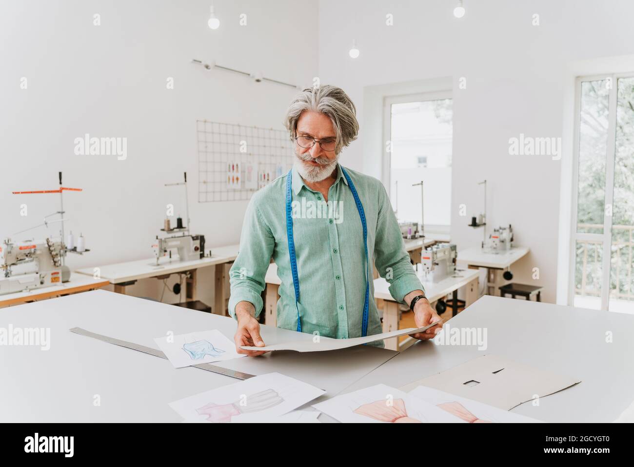 Clothing stylist creating a new design for a dress - Fashion designer ...