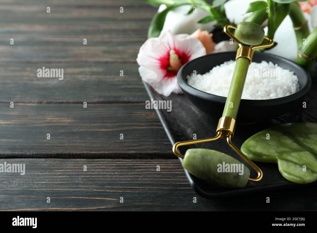 Skin care concept with face roller on wooden table Stock Photo