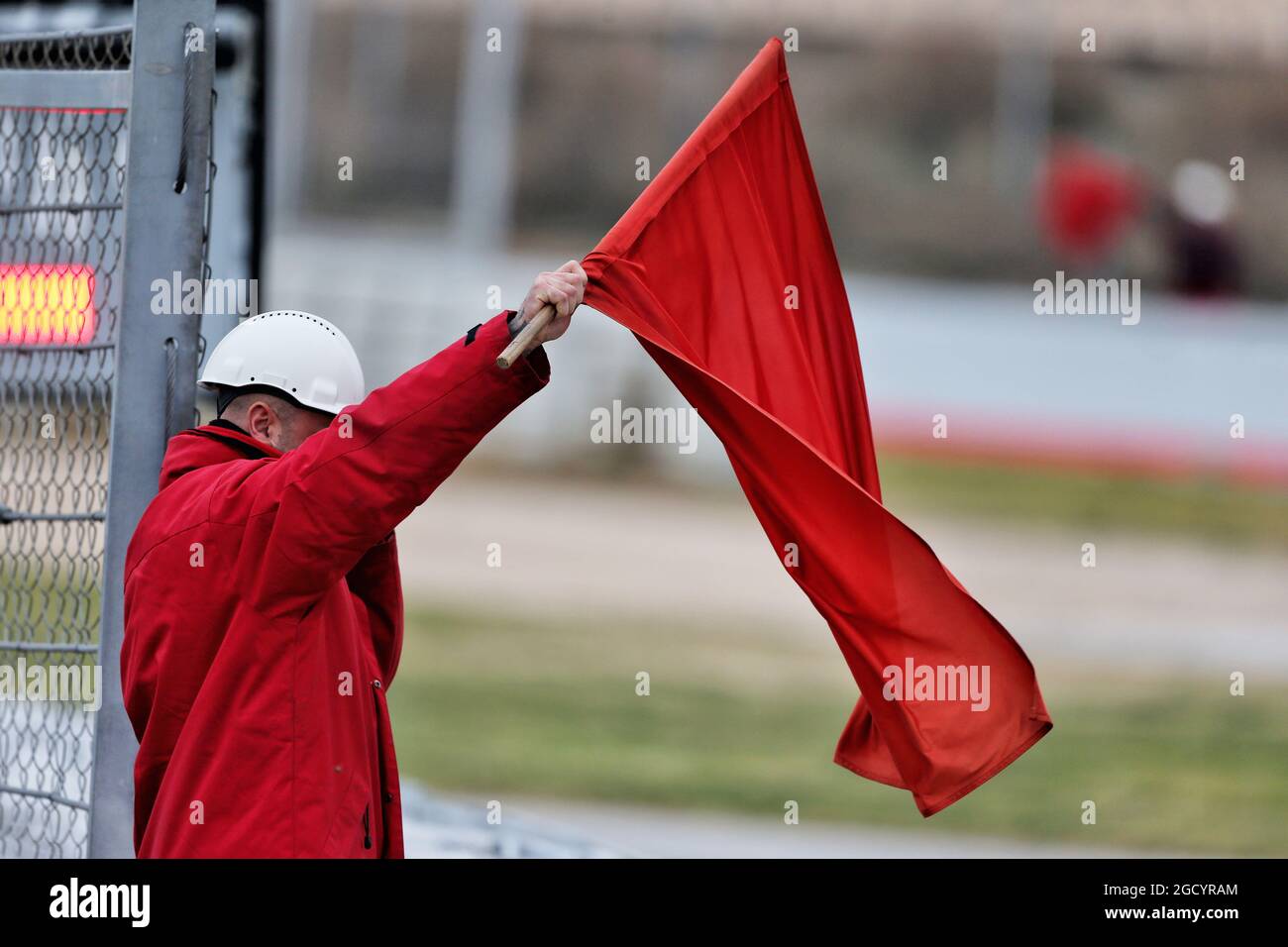 Marshal with a red flag. Formula One Testing, Day 3, Wednesday 20th February 2019. Barcelona, Spain. Stock Photo