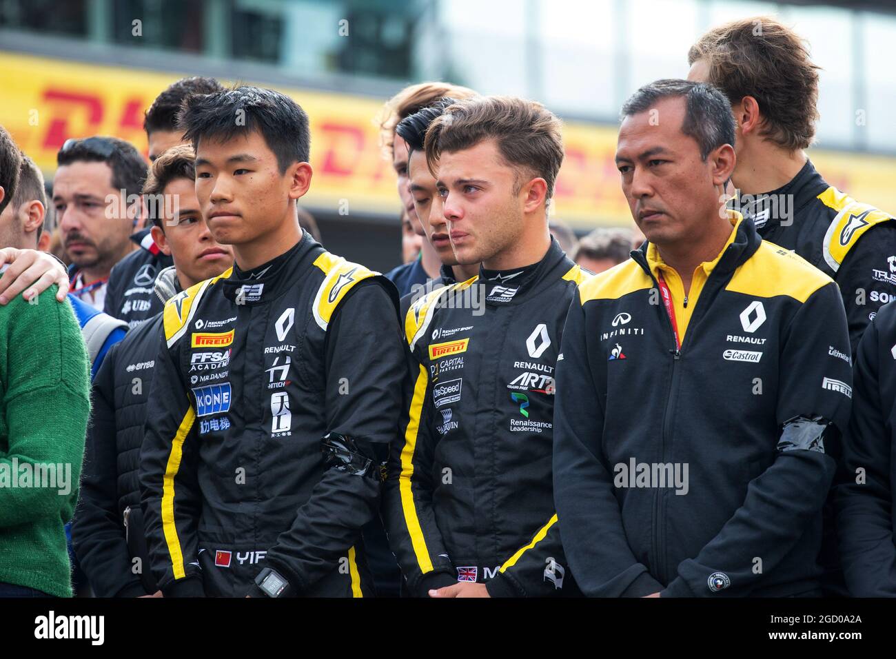 F1, F2, and F3 pay their respects to Anthoine Hubert (L to R): Ye Yifei (CHN) Renault Sport Academy Driver; Max Fewtrell (GBR) Renault Sport Academy Driver; Mia Sharizman (MAL) Renault Sport Academy Director. Belgian Grand Prix, Sunday 1st September 2019. Spa-Francorchamps, Belgium. Stock Photo