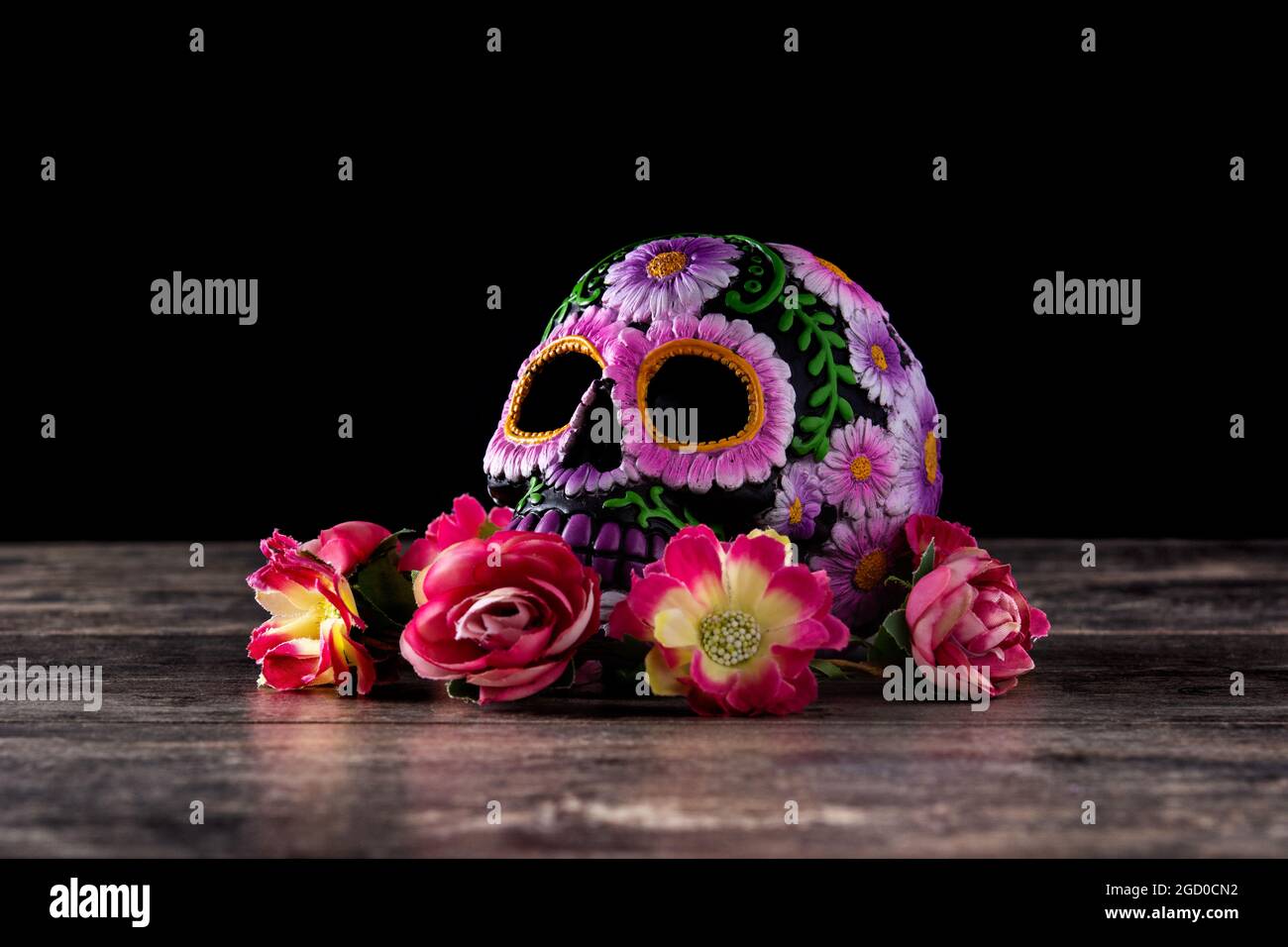 Typical Mexican skull and flowers diadem on black background. Dia de los muertos. Stock Photo