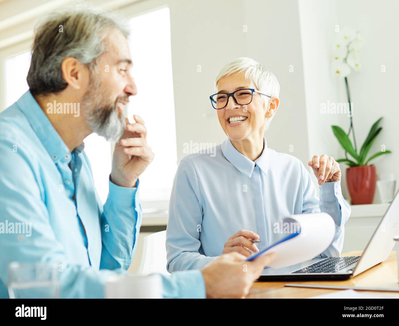 business office person discussion laptop teamwork senior meeting businesswoman businessman together Stock Photo