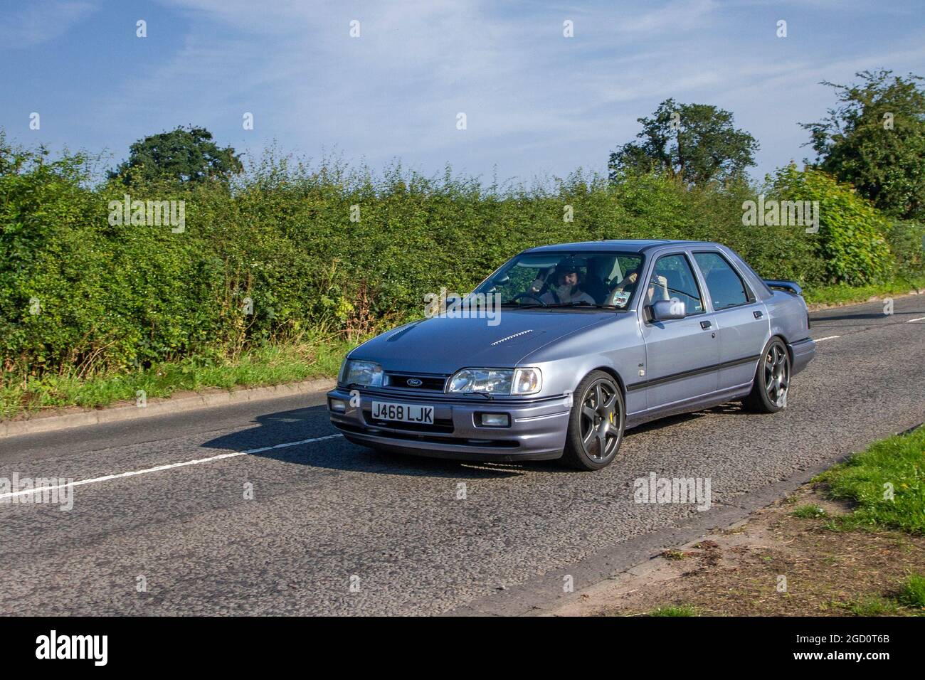 1991 90s grey Ford SAPPHIRE COSWORTH 4x4 5 speed manual 4dr en-route to Capesthorne Hall classic July car show, Cheshire, UK Stock Photo