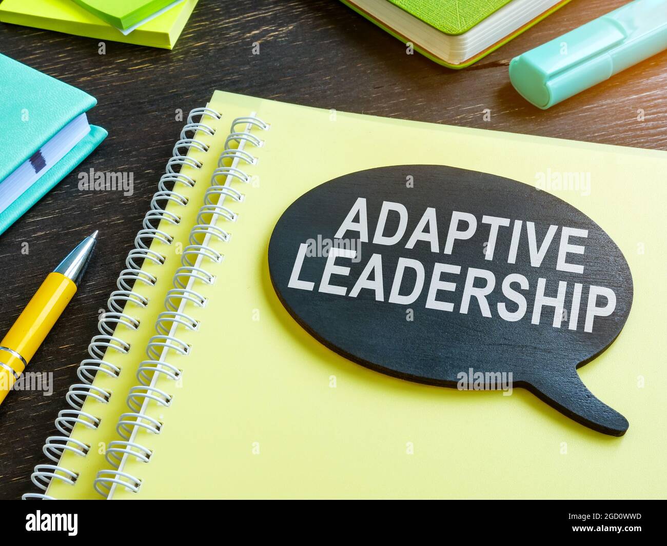 Adaptive leadership phrase on the plate and papers. Stock Photo