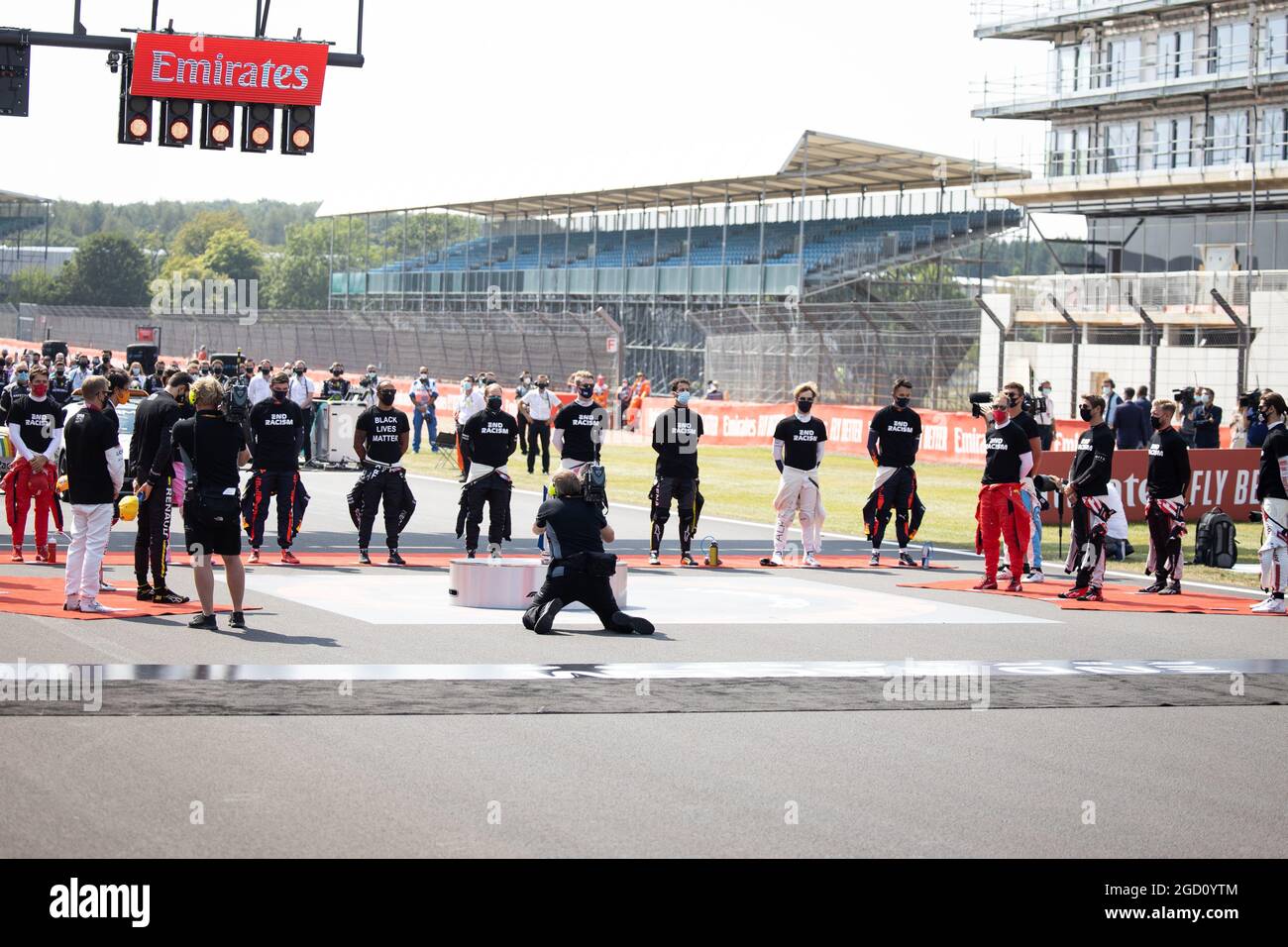 Drivers as the grid observes the national anthem. 70th Anniversary