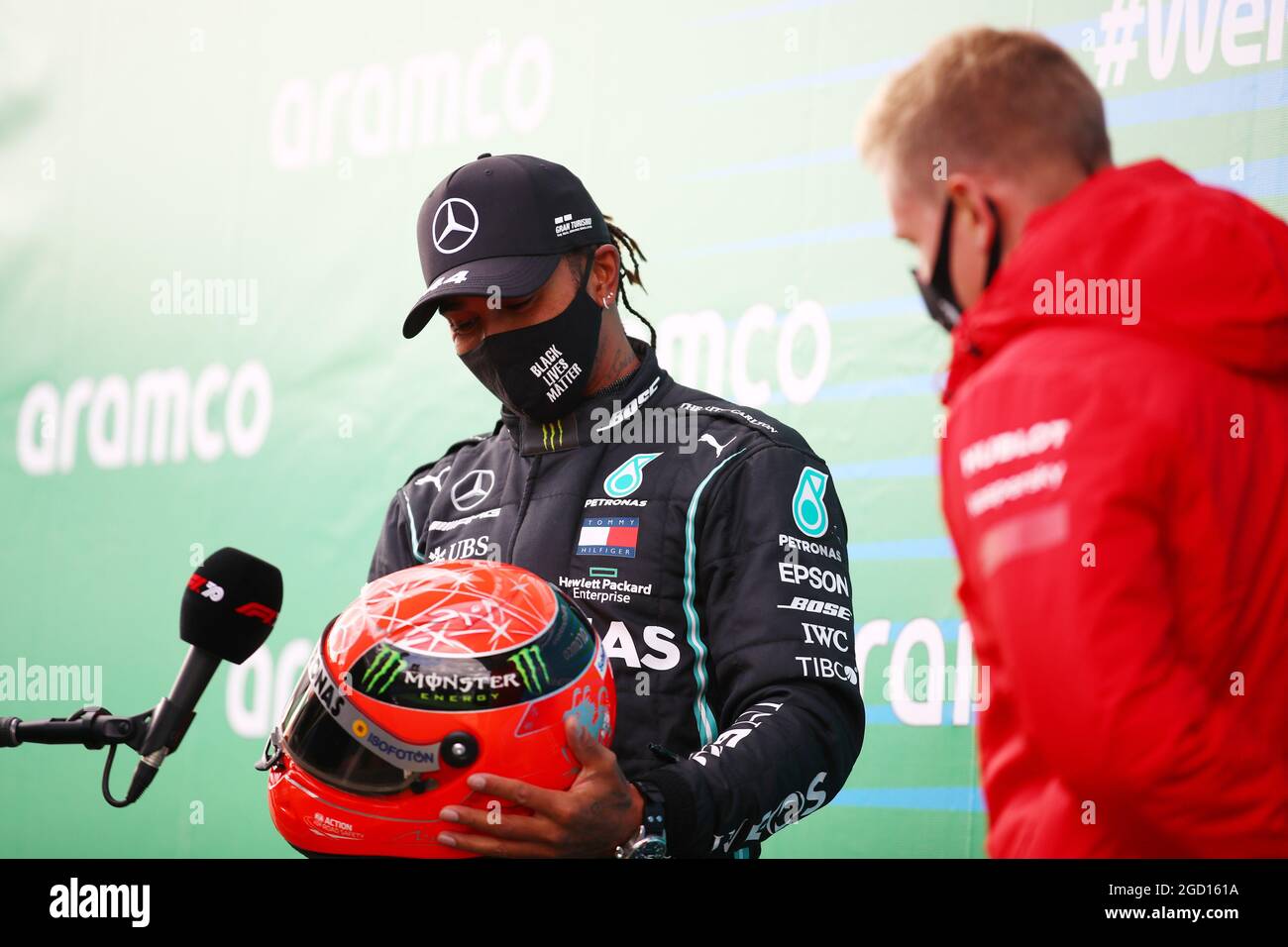 Race winner Lewis Hamilton (GBR) Mercedes AMG F1 is presented with the  helmet of Michael Schumacher (GER) by Mick Schumacher (GER) in parc ferme  after equalling the record for the number of