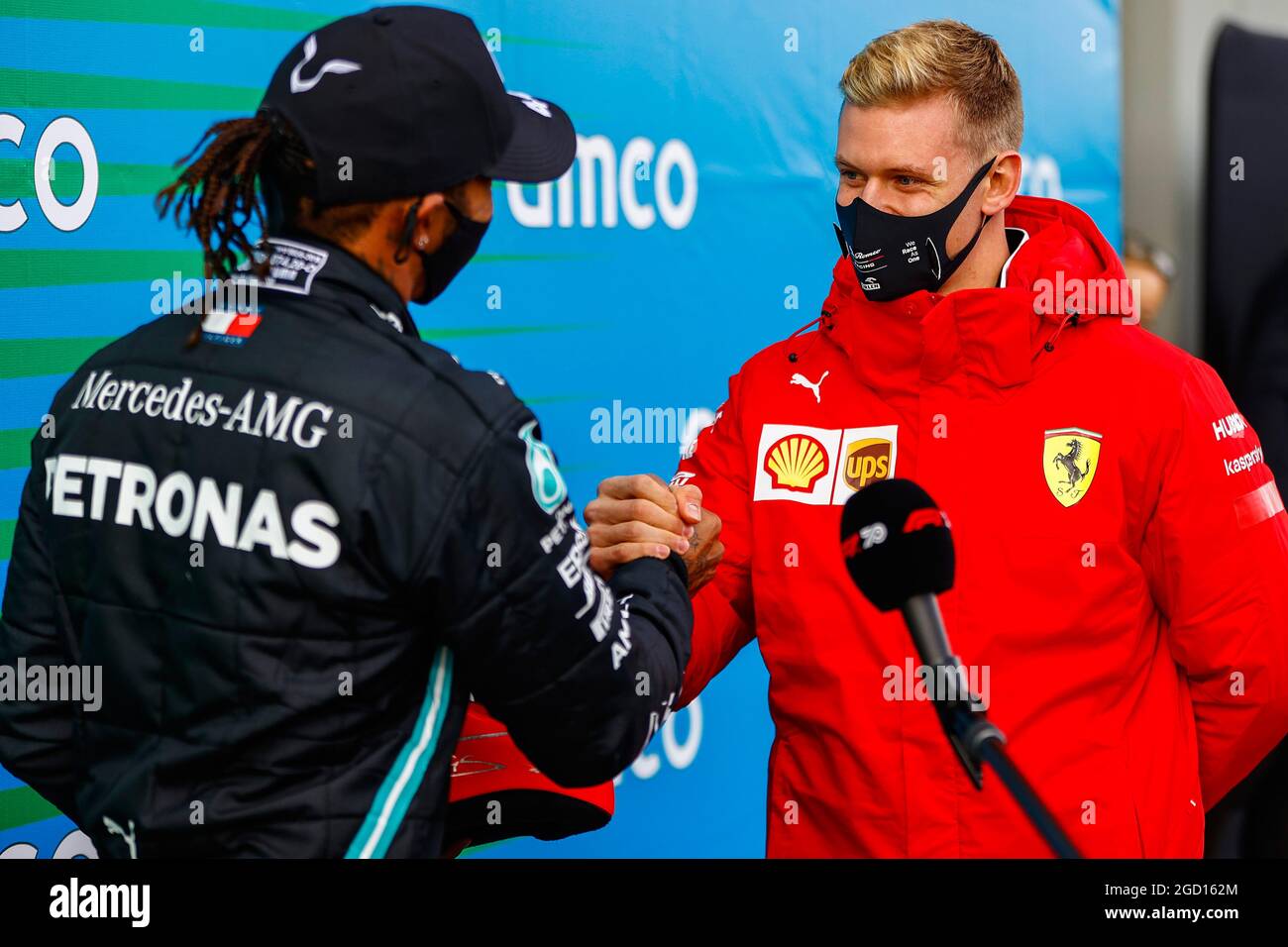 Race winner Lewis Hamilton (GBR) Mercedes AMG F1 is presented with the  helmet of Michael Schumacher (GER) by Mick Schumacher (GER) in parc ferme  after equalling the record for the number of
