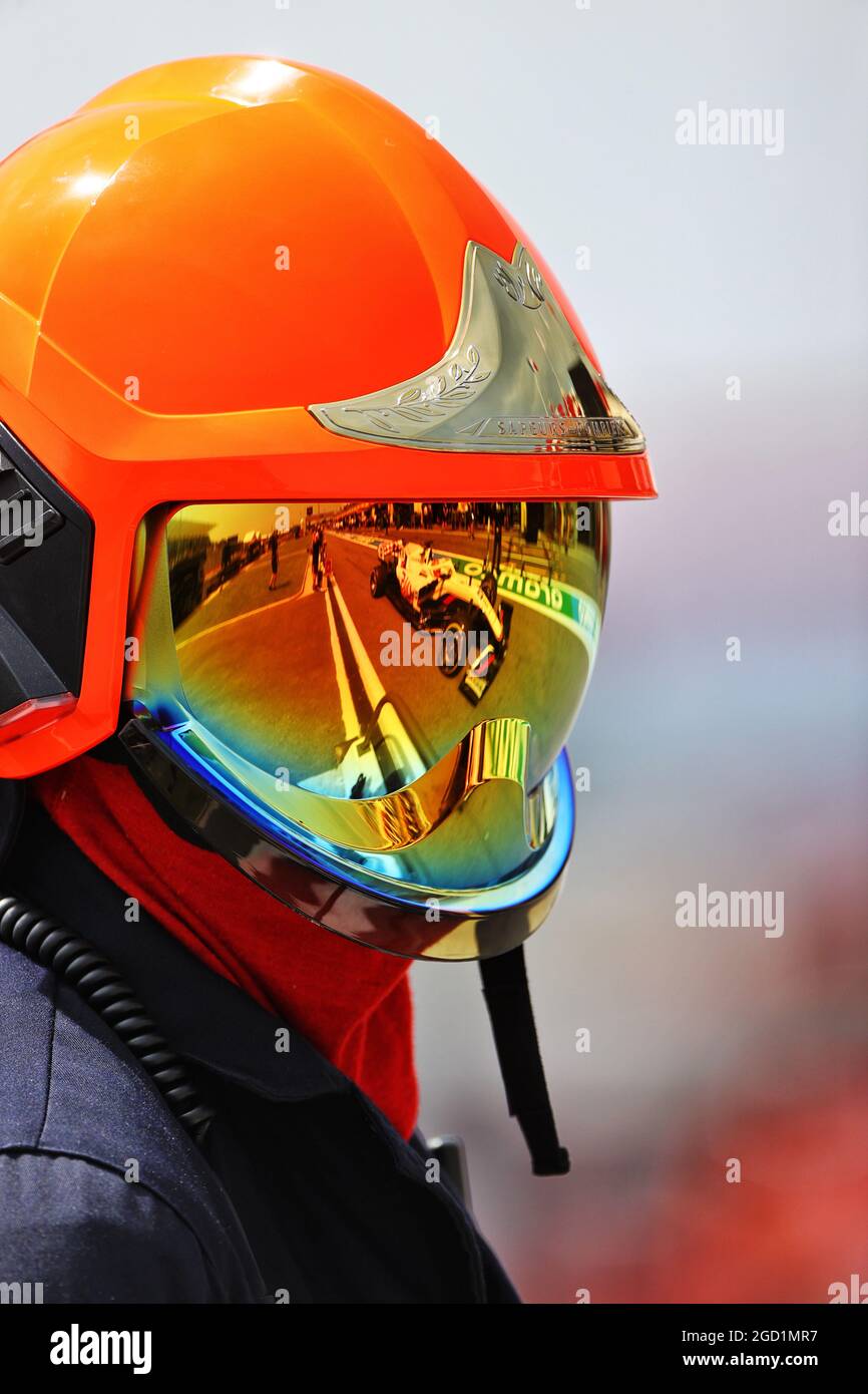 Haas f1 team vf 21 reflected in fire marshals helmet visor hires stock