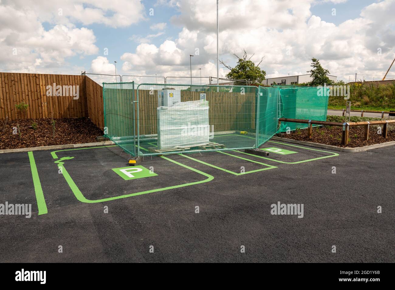 New Lidl store on Poppy Road with a electric charging station covered up and fenced off not ready for charging cars. Stock Photo
