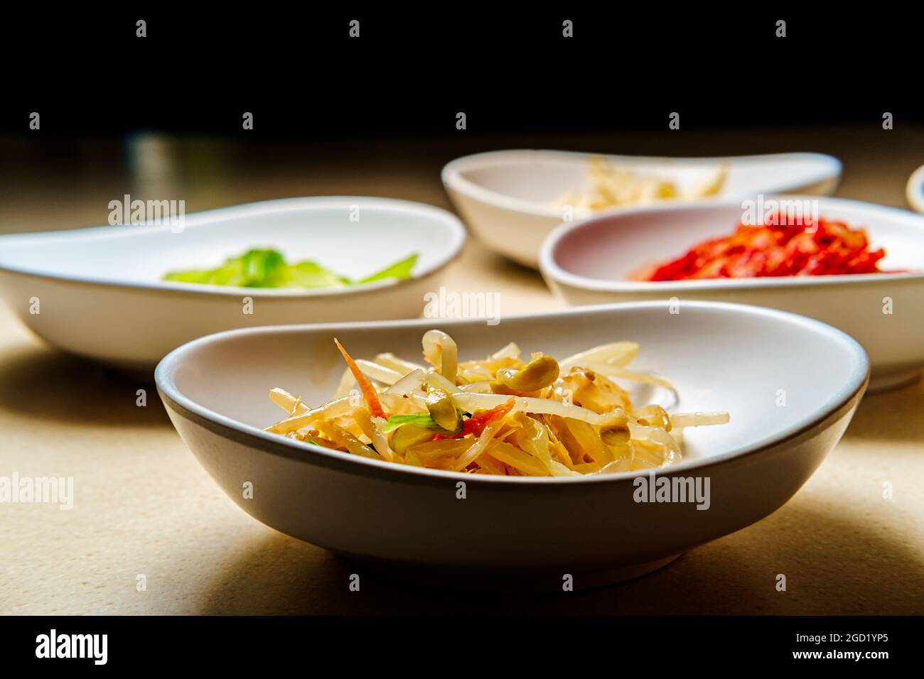 Korean dinner banchan side dishes including kimchi and soybeans Stock
