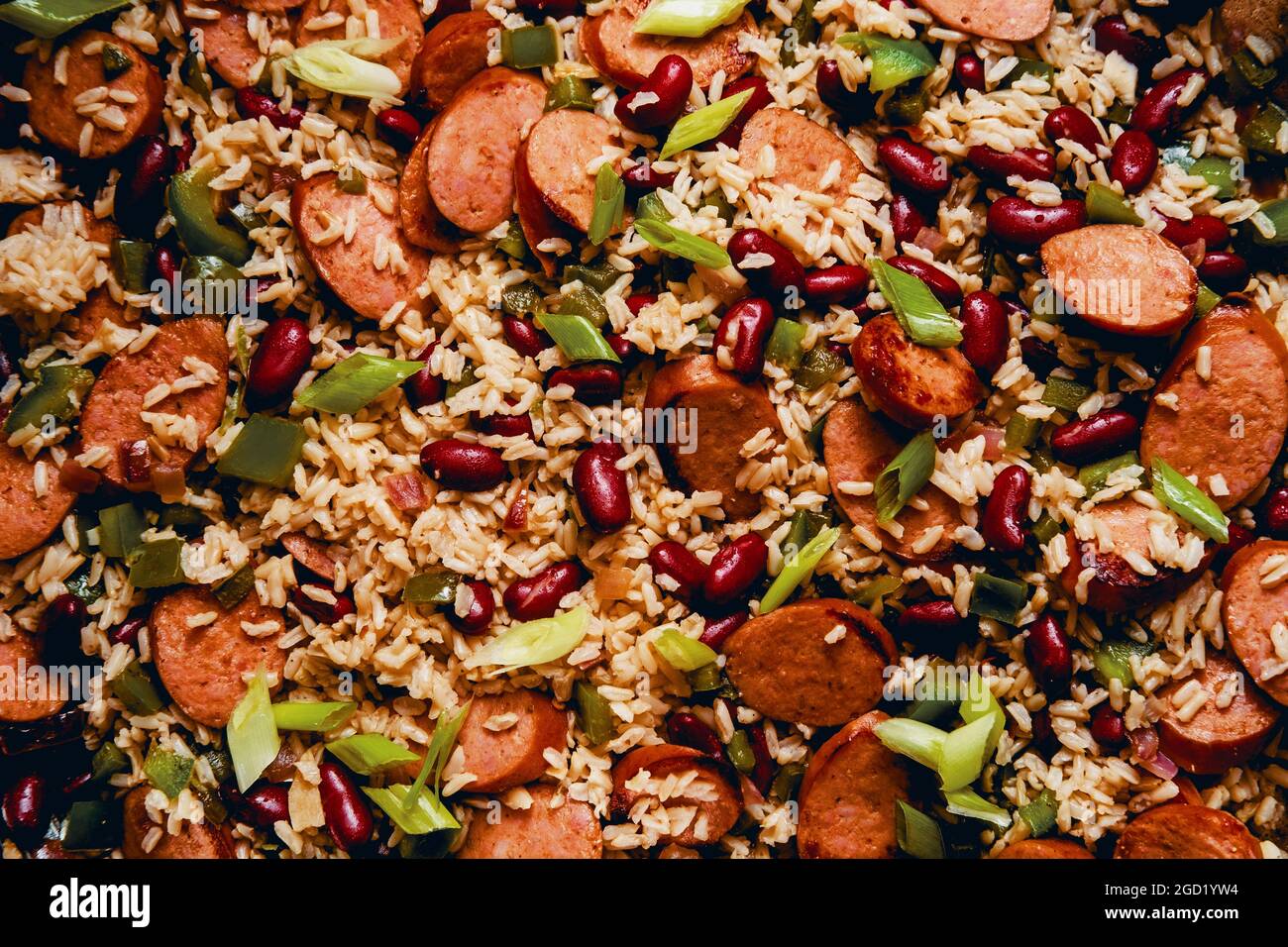 Cooking skillet red beans and rice with smoked andouille sausage and