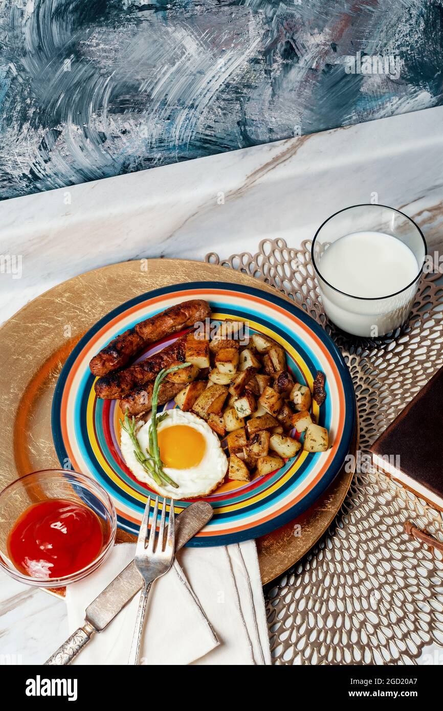 Complete American breakfast fried sunny side up eggs sausage potatoes o