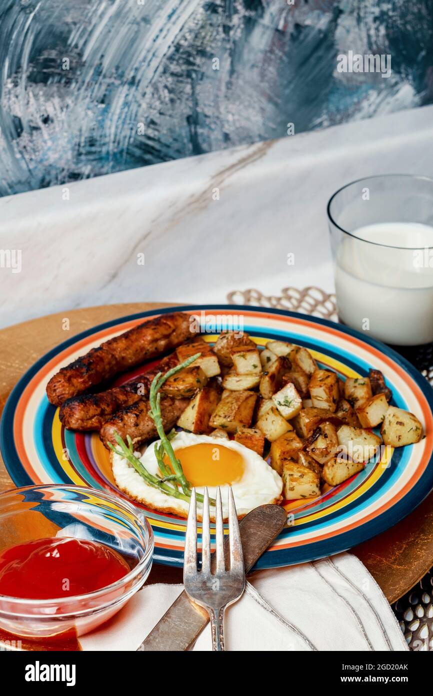 Complete American breakfast fried sunny side up eggs sausage potatoes o