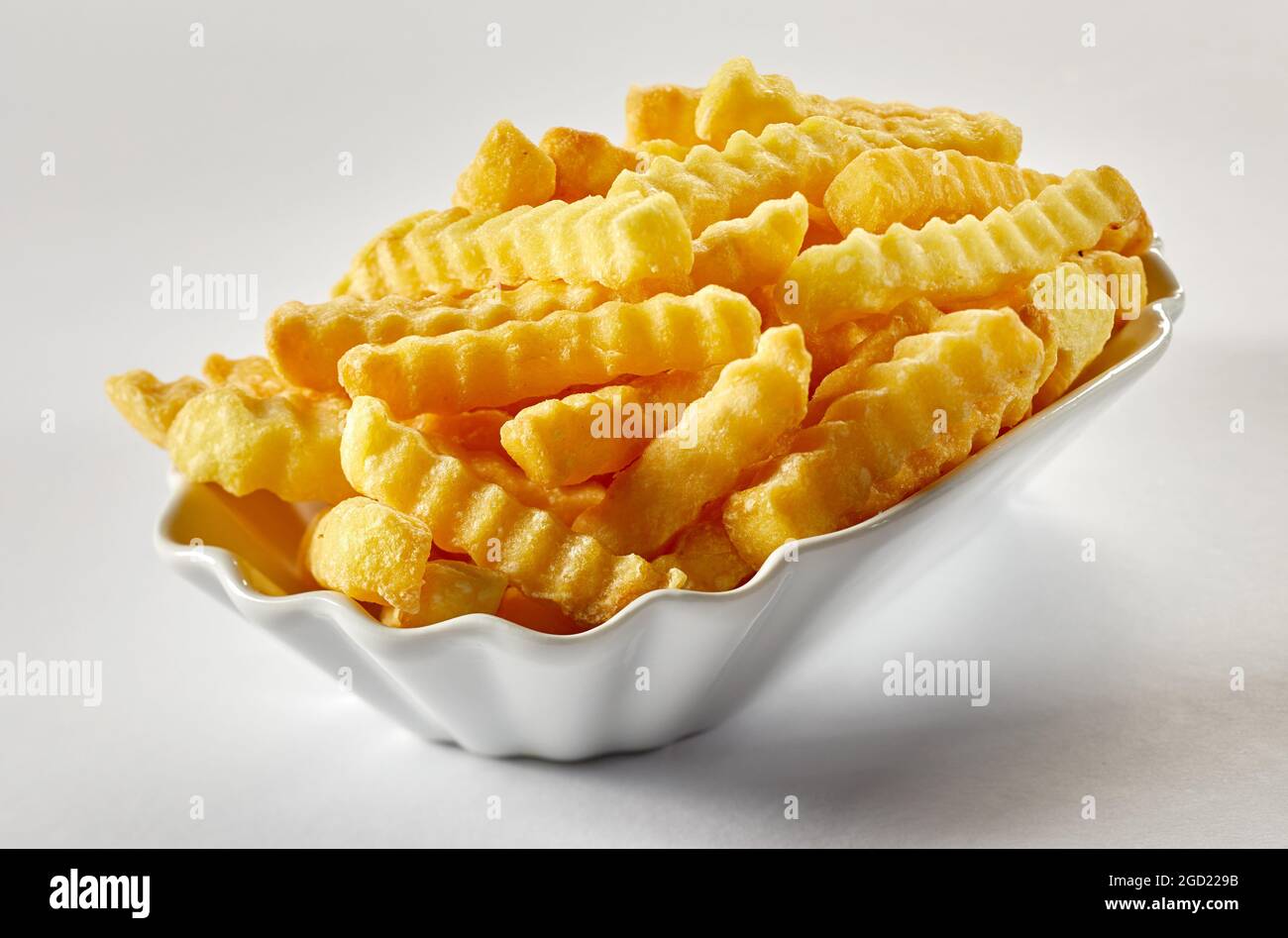 Delicious deep fried potato sticks with golden ribbed surface in