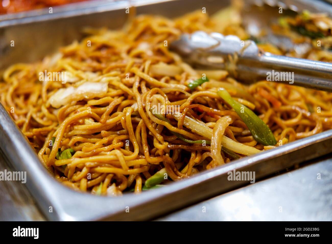 Chinese vegetable lo mein buffet serving tray with tongs Stock Photo Alamy