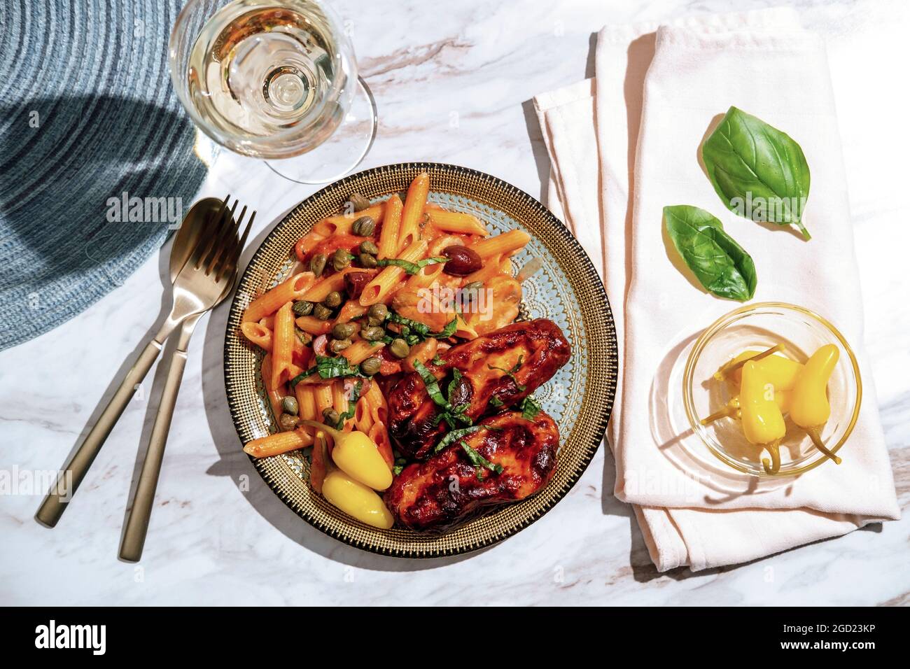 Penne alla zingara with Italian pink vodka sauce and mozzarella cheese  stuffed sausage with pickled yellow chili peppers Stock Photo - Alamy