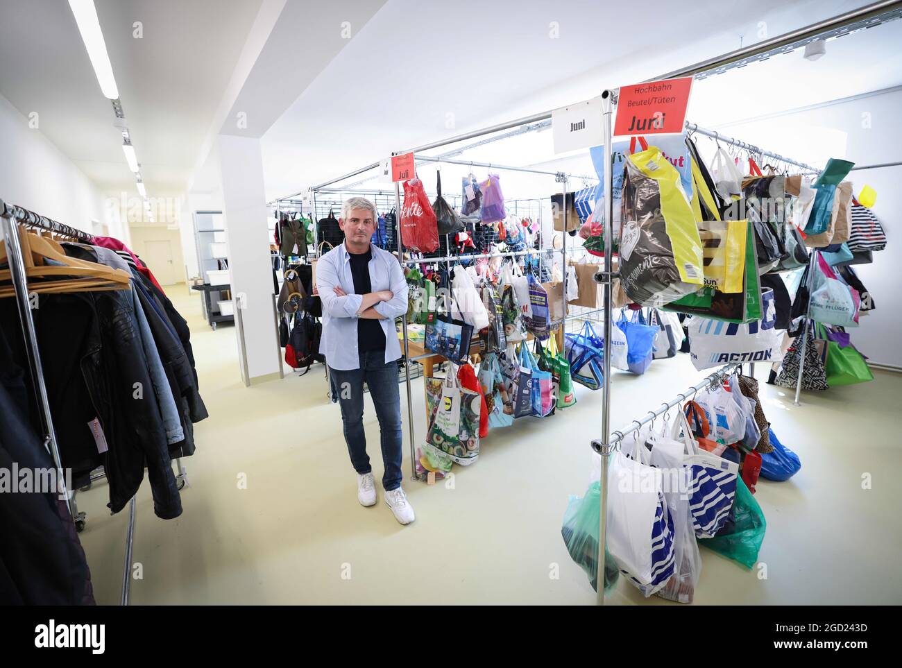 Hamburg, Germany. 10th Aug, 2021. Peter Jander, Head of the Central Lost Property Office Hamburg, stands among lost property at the inauguration of the new lost property office. Germany's largest lost property office employs 16 people, who together process around 50,000 lost property items a year. Credit: Christian Charisius/dpa/Alamy Live News Stock Photo