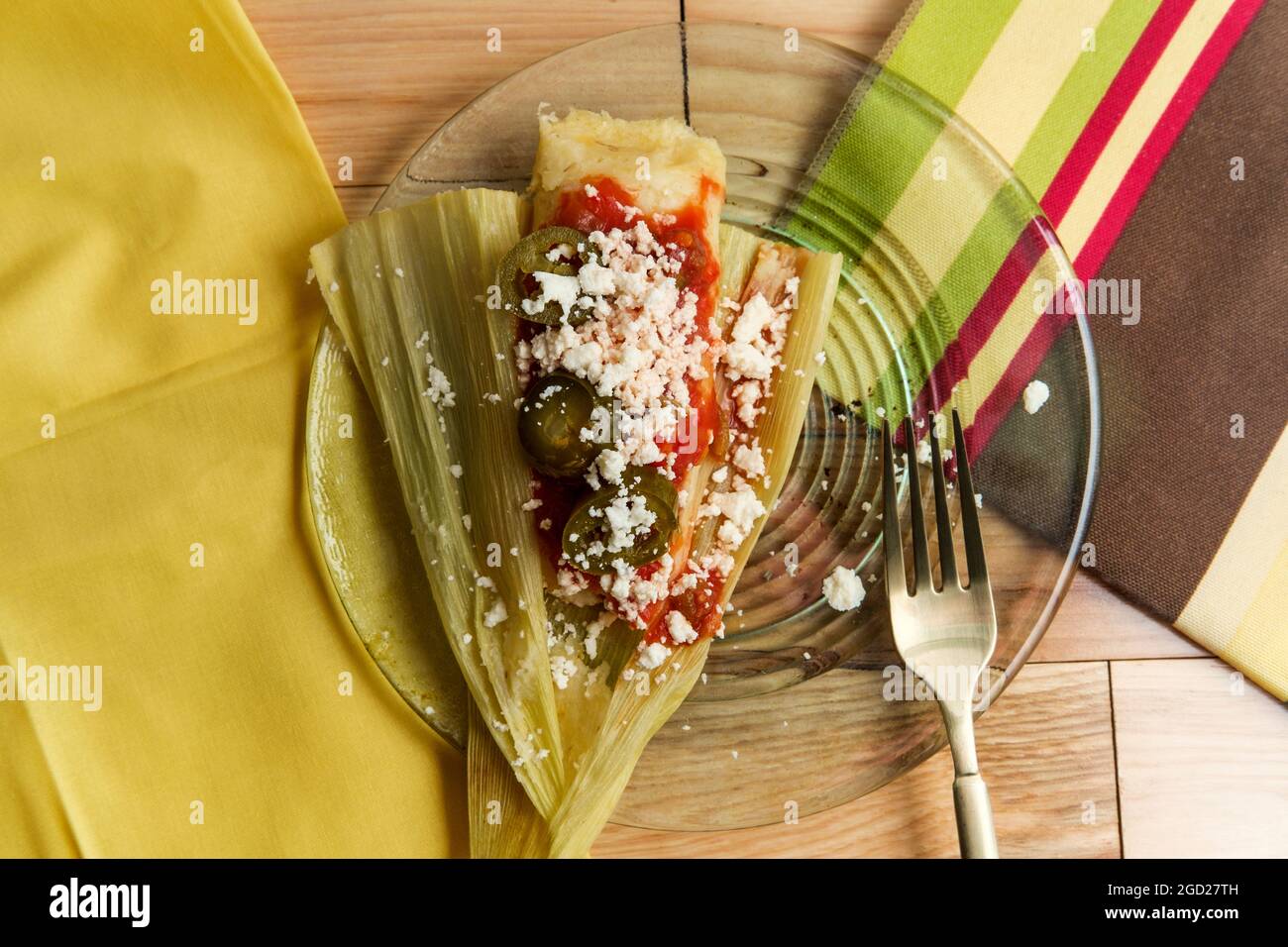 Mexican steamed chili and cheese masa tamales wrapped in corn husk