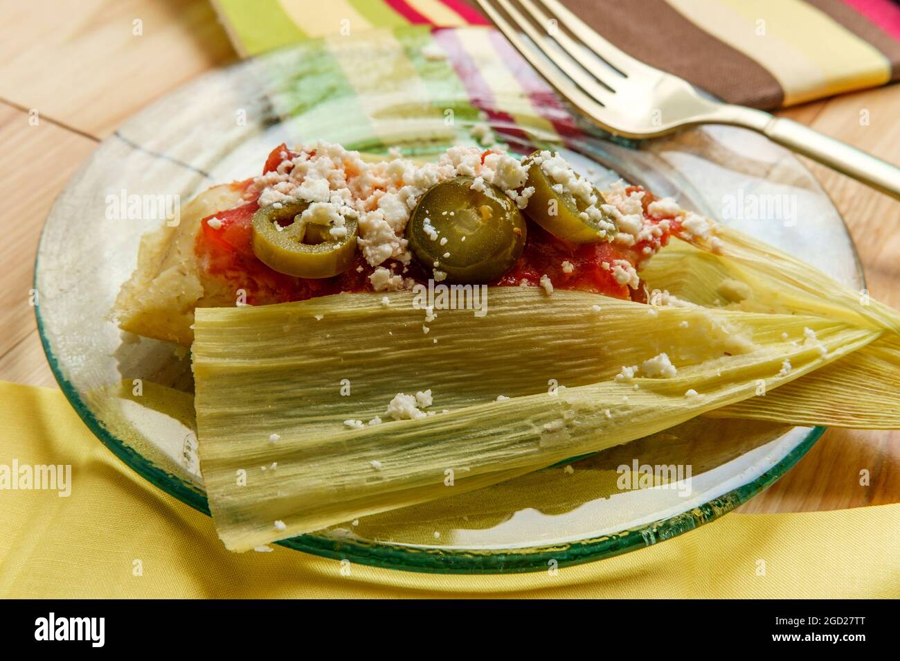 Mexican steamed chili and cheese masa tamales wrapped in corn husk