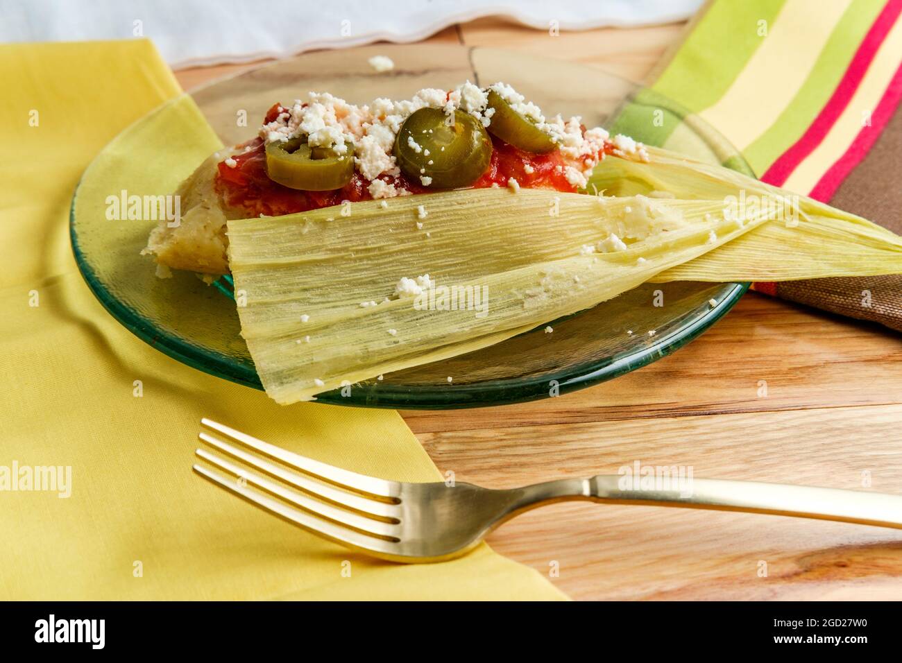 Mexican steamed chili and cheese masa tamales wrapped in corn husk