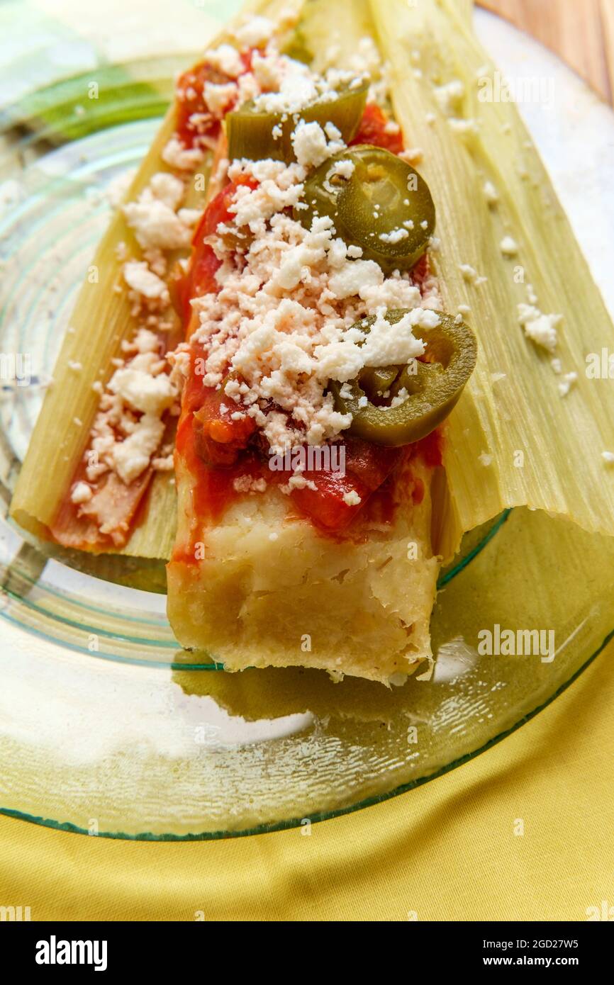 Mexican steamed chili and cheese masa tamales wrapped in corn husk