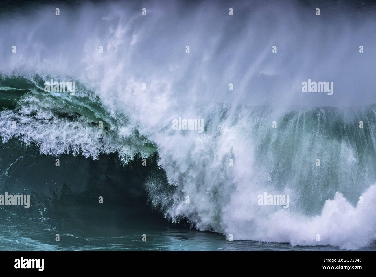 A wild wave breaking on the Cribbar Reef off Towan Head in Newquay in Cornwall. Stock Photo