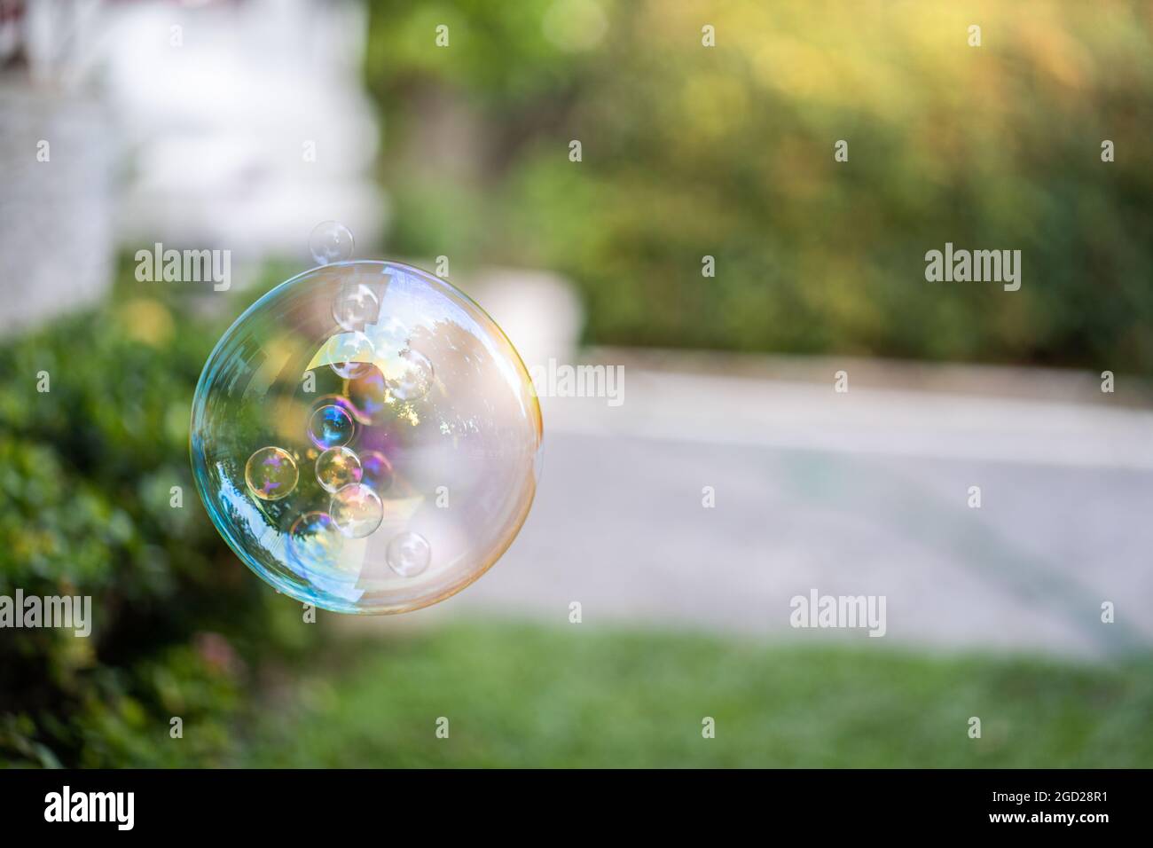 Floating soap bubble in a garden Stock Photo - Alamy