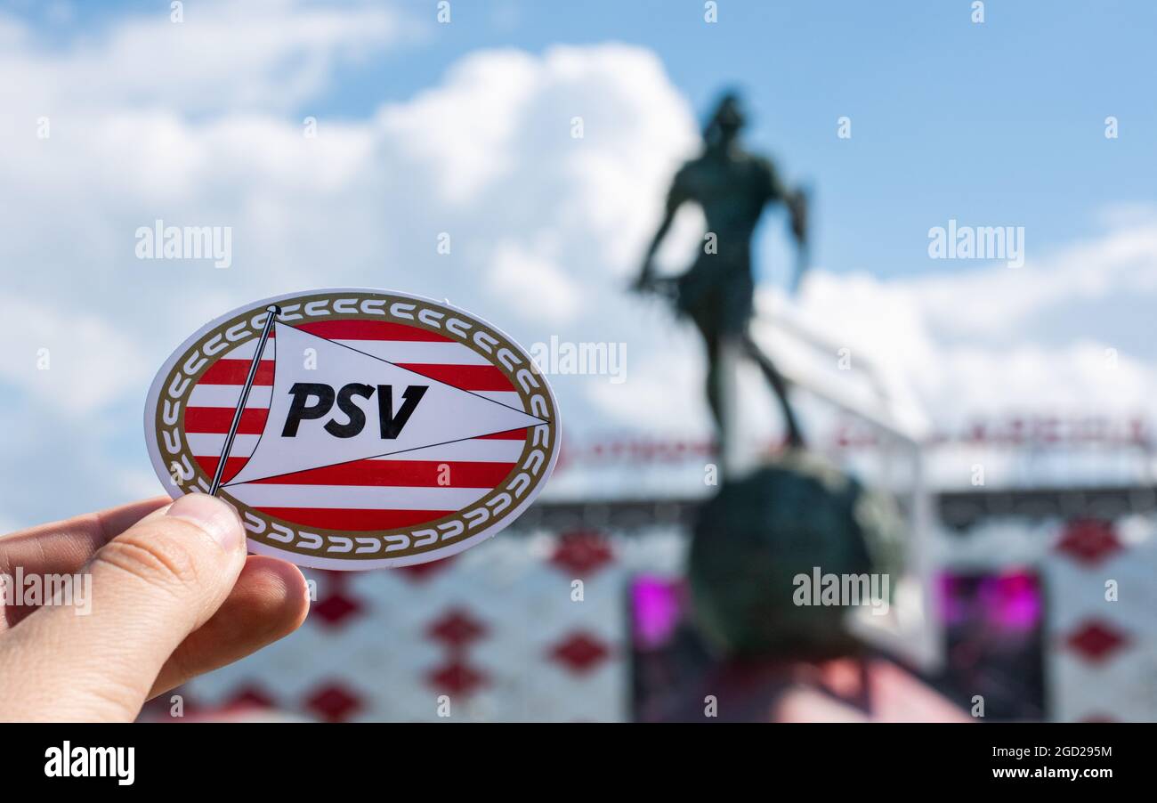 June 14, 2021 Eindhoven, Netherlands. The emblem of the PSV Eindhoven football club against the background of a modern stadium. Stock Photo