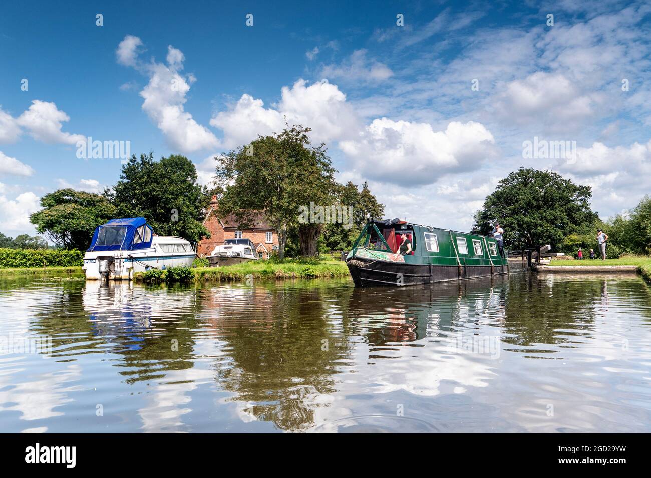 Staycation River Wey Navigations traditional holiday hire narrowboat with family leaving Papercourt Lock on a summers day River Wey Surrey England UK Stock Photo