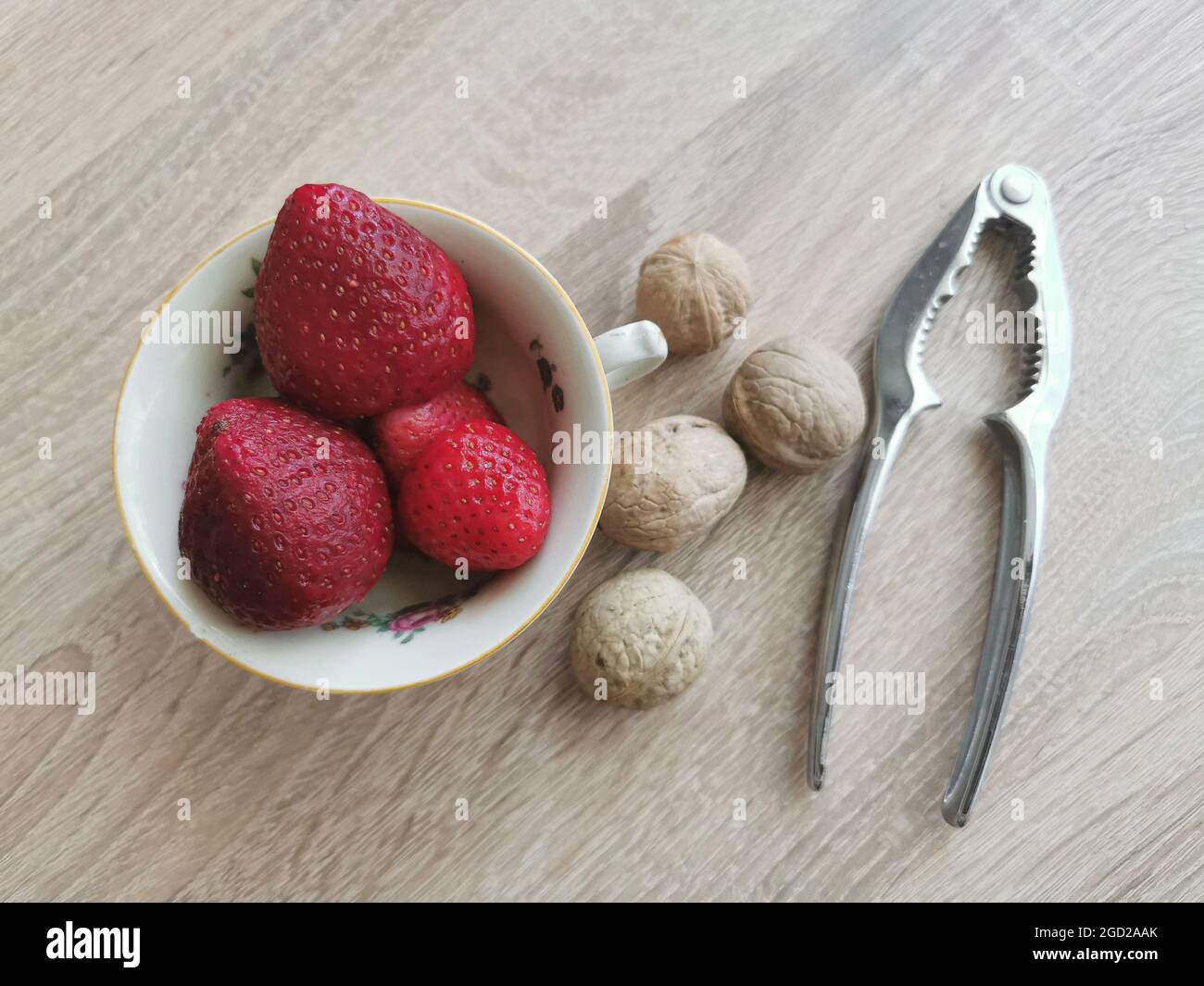 Fresh strawberries, walnuts and nutcracker Stock Photo
