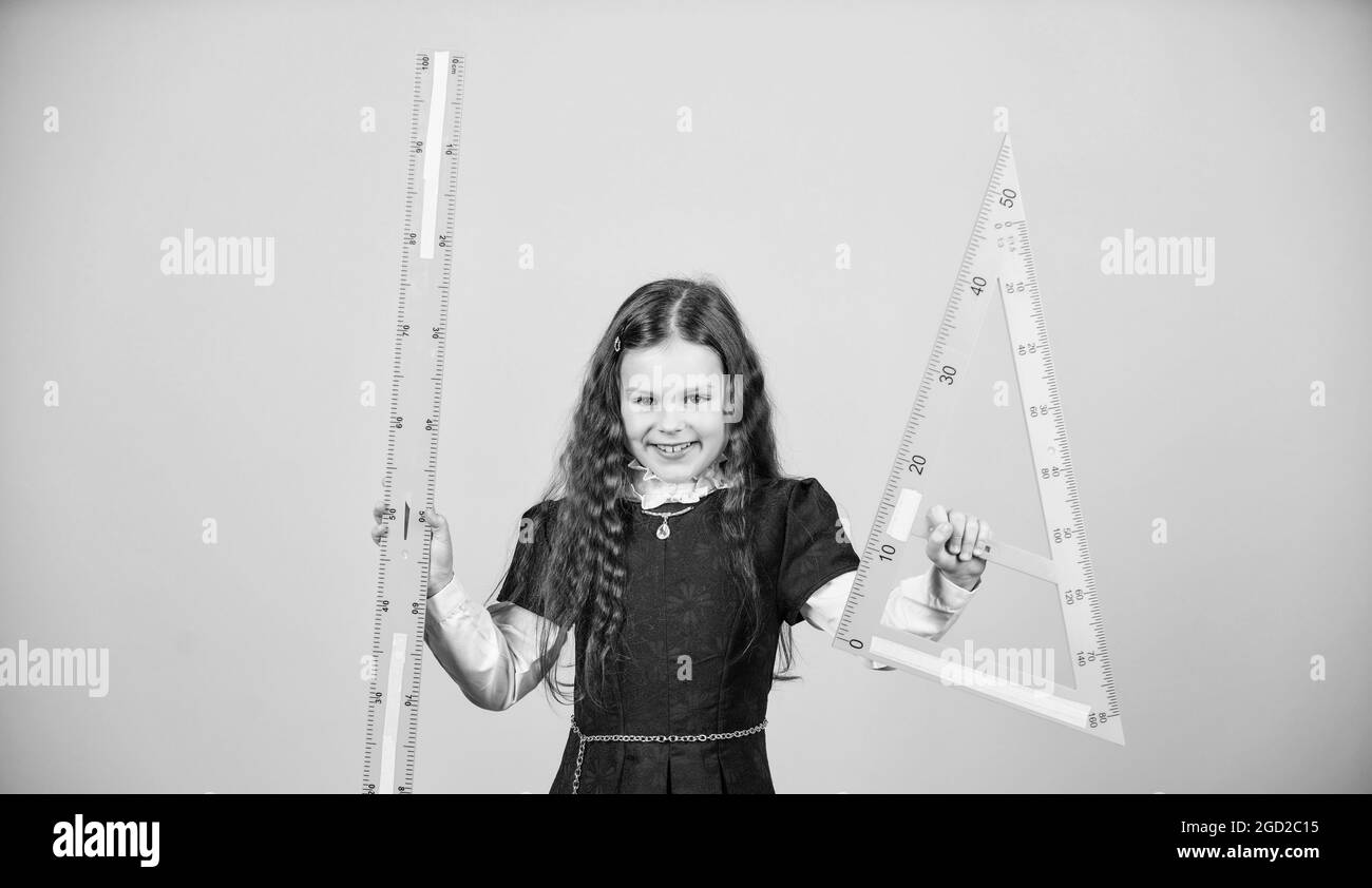 Pupil Using Ruler Sizing and measuring. Pupil cute girl with big ruler. School student ...