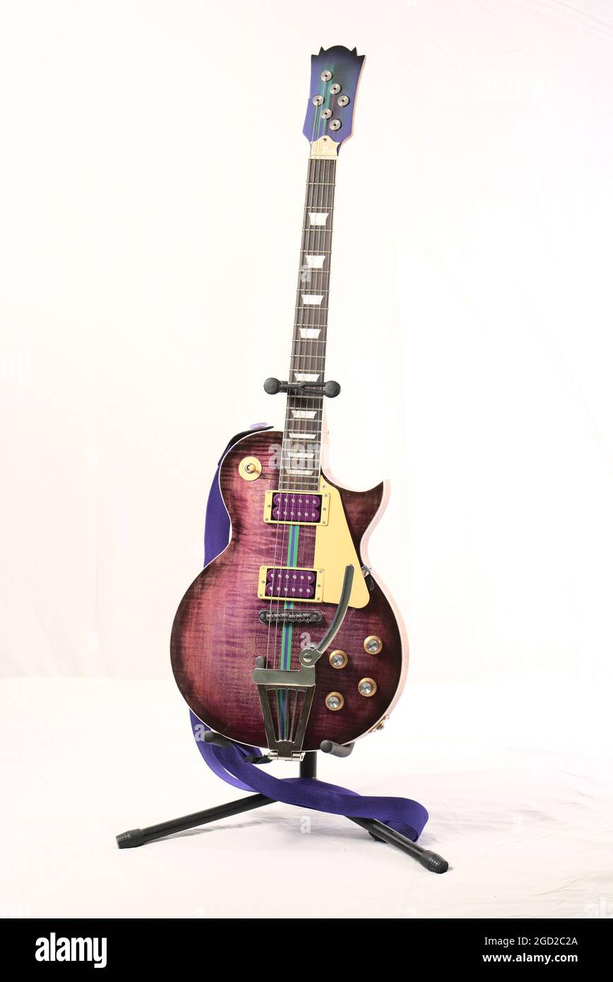 Vintage electric guitar on a stand isolated on a white background Stock