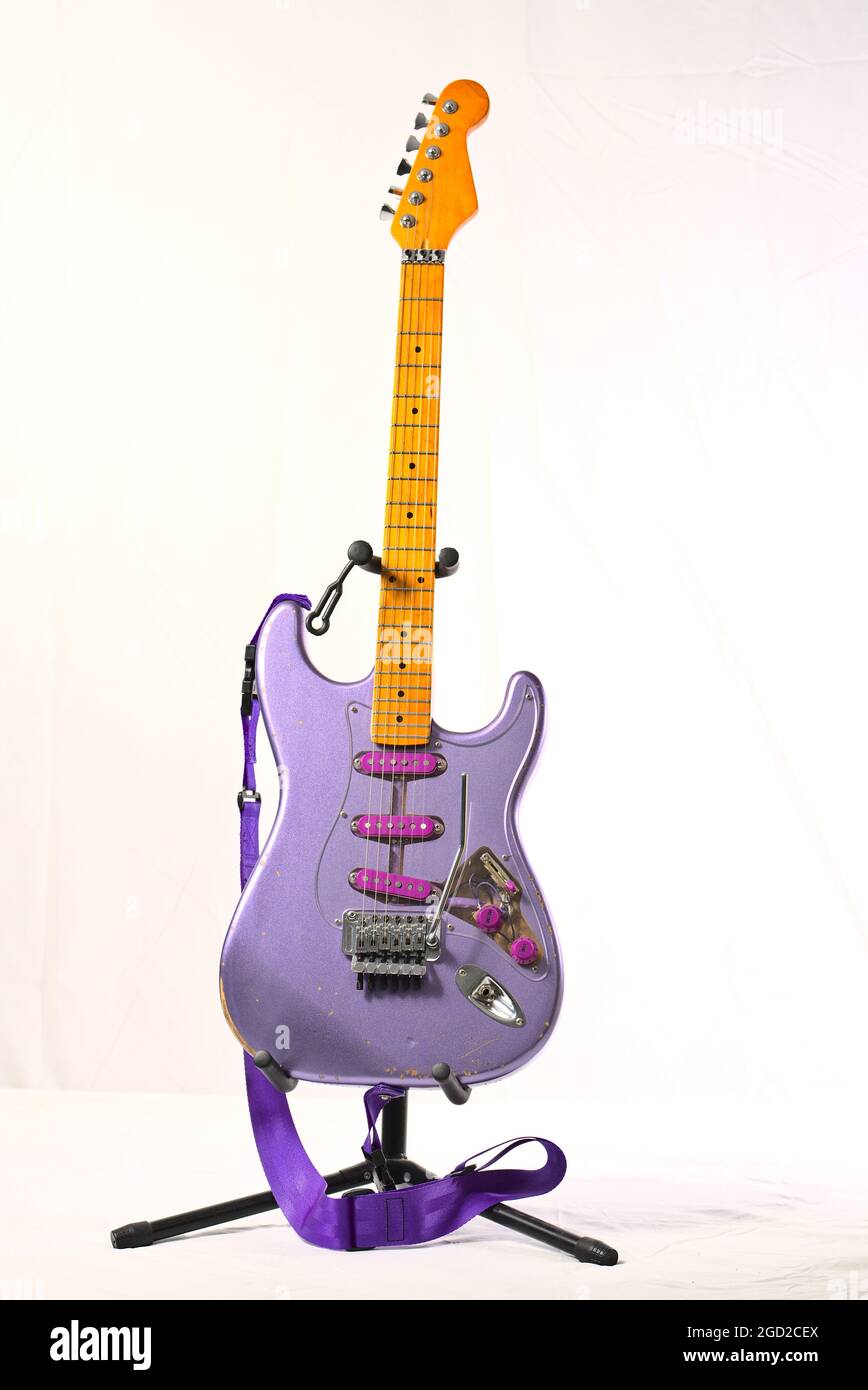 Vintage electric guitar on a stand isolated on a white background Stock