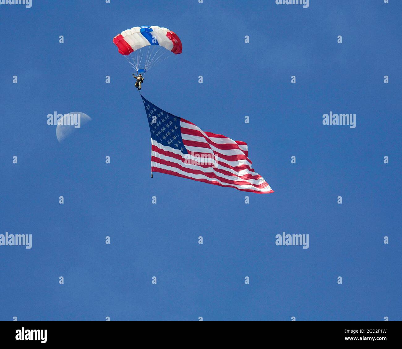 American Flag arrives in style with moon in the background Stock Photo