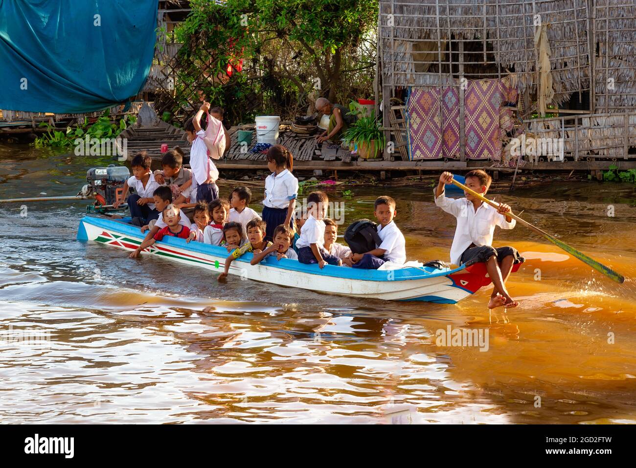 Tonle Sap lake, Cambodia - January 04, 2017: Students on a full boat return home after school. About 80,000 people live on the water permanently Stock Photo