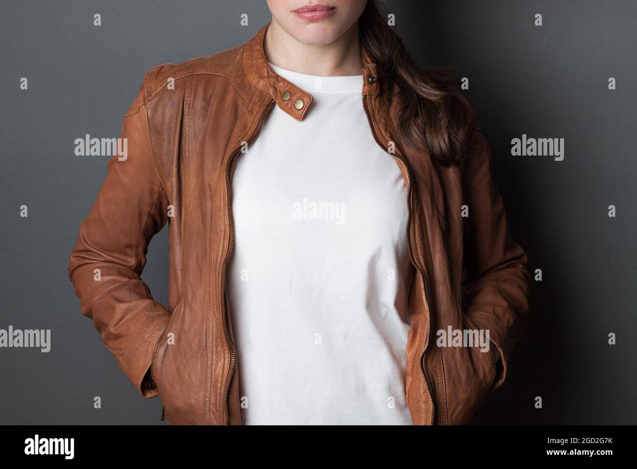 Young woman in a white t-shirt and brown leather jacket Stock Photo - Alamy